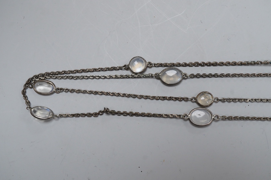 A silver and moonstone longchain necklace, set with cabochon moonstones, connected by a fine link chain, length 128cm, Condition: overall good condition, attractive moonstones and nice design. Silver with typical tarnish